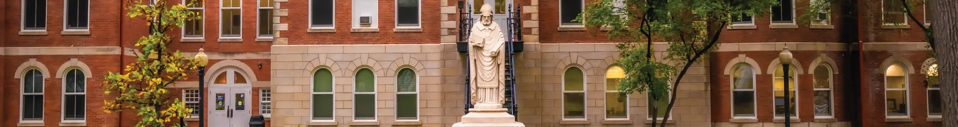 Statue of St. Ambrose outside Ambrose Hall.